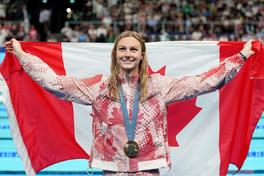 Canada's Summer McIntosh, of Toronto, celebrates with her gold medal won in the 200m women's individual medley final during the 2024 Summer Olympic Games, in Nanterre, France, Saturday, Aug. 3, 2024. THE CANADIAN PRESS/Christinne Muschi.