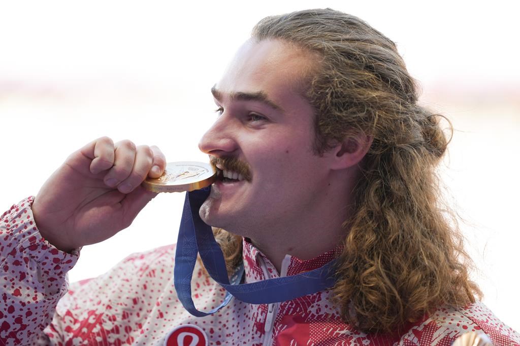 Ethan Katzberg, of Nanaimo, B.C., poses with his gold medal in the men's hammer throw event at the 2024 Summer Olympics, Monday, Aug. 5, 2024, in Saint-Denis, France. THE CANADIAN PRESS/Christinne Muschi.