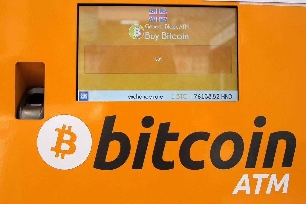 A Bitcoin ATM is seen in Hong Kong on May 11, 2018. A panel of the British Columbia Securities commission has found a crypto trading platform and its owner lied to customers and diverted about $13 million in assets to gambling and personal accounts. THE CANADIAN PRESS/AP, Kin Cheung.