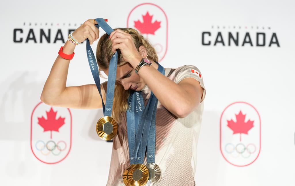 Canada's Summer McIntosh of Toronto poses with her four medals won in the pool at the 2024 Summer Olympics, Aug. 5, 2024 in Paris, France. The three gold medals were for the 200m Butterfly, the 200m Individual Medley and the 400m Individual Medley and the one silver was for the 400m Freestyle. The Paris Games are over and the Summer Olympics torch is moving on to Los Angeles in 2028. THE CANADIAN PRESS/Christinne Muschi.