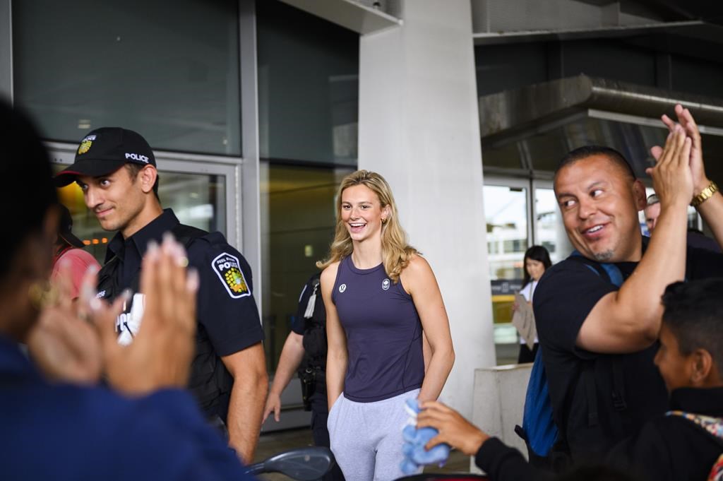 Olympic medalist Summer McIntosh is cheered by fans after arriving at Pearson airport following the 2024 Paris Olympic Games, in Toronto, Monday, Aug. 12, 2024. THE CANADIAN PRESS/Christopher Katsarov.