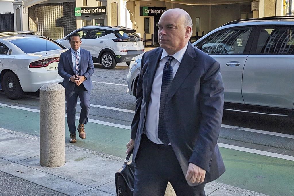 FILE - British tech magnate Mike Lynch walks into federal court in San Francisco, March 26, 2024.
