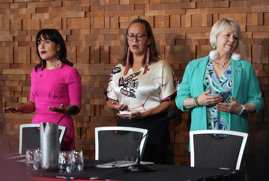From left, B.C. Deputy Provincial Health Officer for Indigenous Health Dr. Daniele Behn Smith, First Nations Health Authority Chief Medical Officer Dr. Cornelia Wieman and B.C. Provincial Health Officer Dr. Bonnie Henry stand during a song before a news conference, in Vancouver, on Wednesday, August 21, 2024. The First Nations Health Authority and the office of the provincial health officer released an interim update related to the First Nations Population Health and Wellness Agenda. THE CANADIAN PRESS/Darryl Dyck.