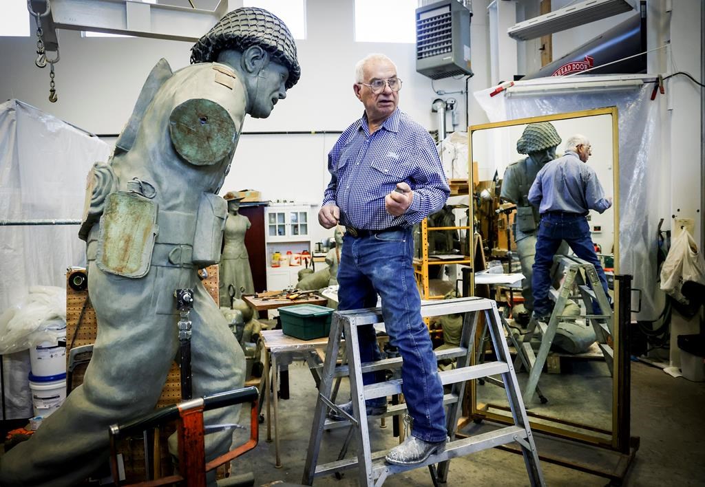 Bronze sculptor Don Begg, makes adjustments to a bronze statue depicting a Second World War Canadian soldier. Begg will be receiving the Alberta Order of Excellence for his work over the decades and is pictured in his workshop in Cochrane, Alta., Monday, Aug. 19, 2024.THE CANADIAN PRESS/Jeff McIntosh.
