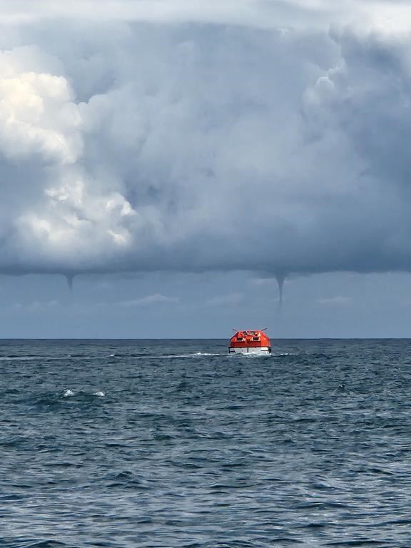 The Northern Tornadoes Project has confirmed several waterspouts were recorded in Ontario, Quebec and Nova Scotia during the month of August. Two waterspouts form in the distance as a vessel, foreground, is seen in the waters near Îles-de-la-Madeleine, Que., in a Friday, Aug. 23 handout photo. THE CANADIAN PRESS/HO-Marc-Andre Bourgeois-Gaudet
