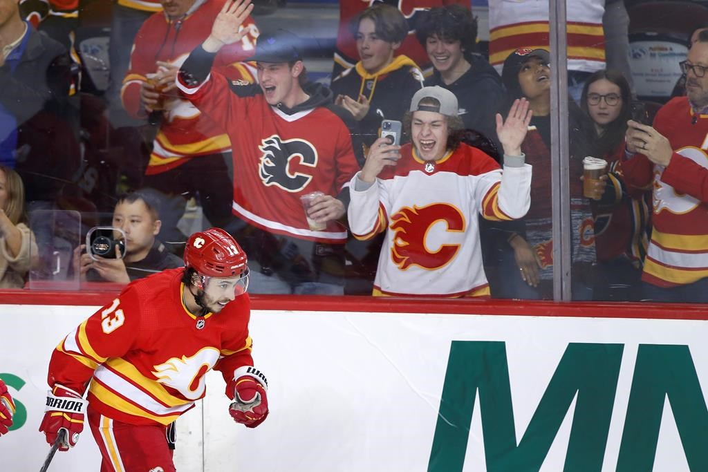 Calgary Flames left wing Johnny Gaudreau celebrates his 100th season point, an assist, during NHL hockey action against the Seattle Kraken in Calgary on April 12, 2022. Gaudreau and his brother Matthew were killed Thursday when they were hit by a car while cycling in their home state of New Jersey.