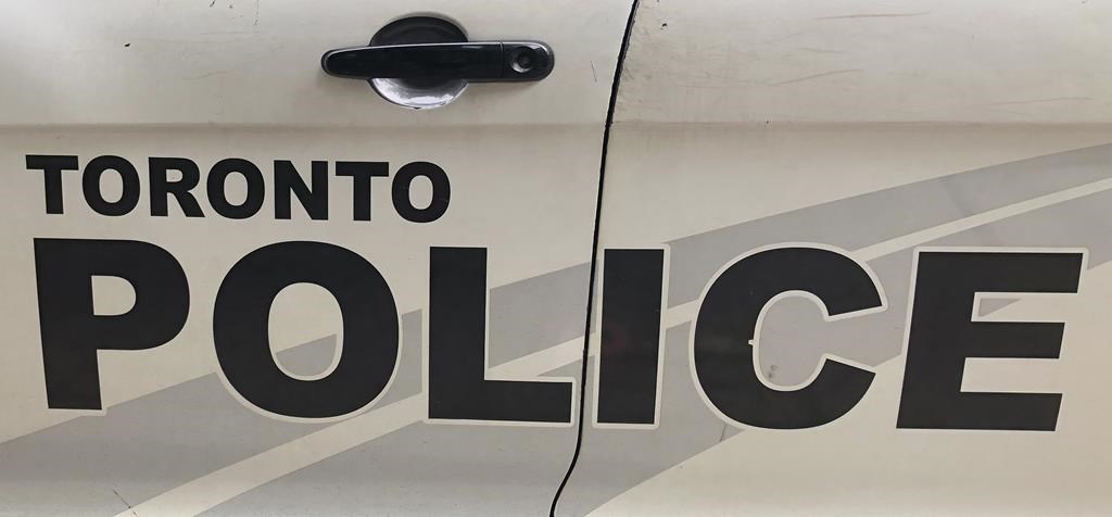 The side of a Toronto police vehicle is shown in Toronto on Aug. 2, 2023. Toronto police say they are treating the death of a woman found at the scene of a house fire earlier this week as a homicide. 