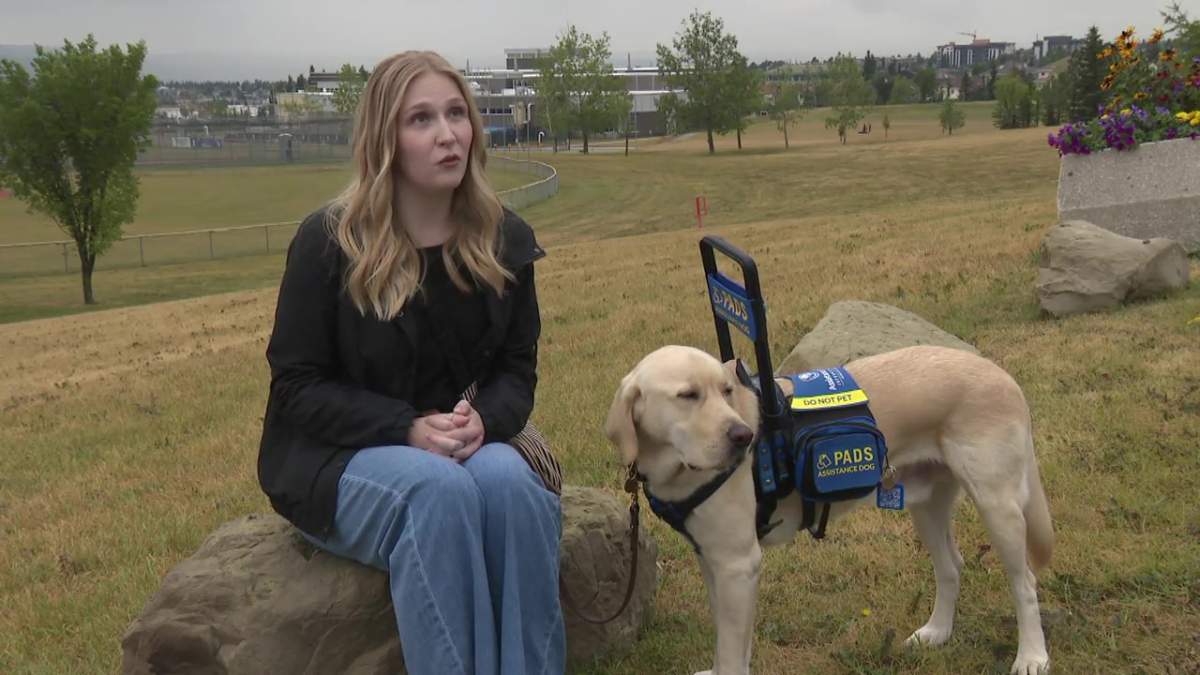 Taylor Nile with her assistance dog Dash