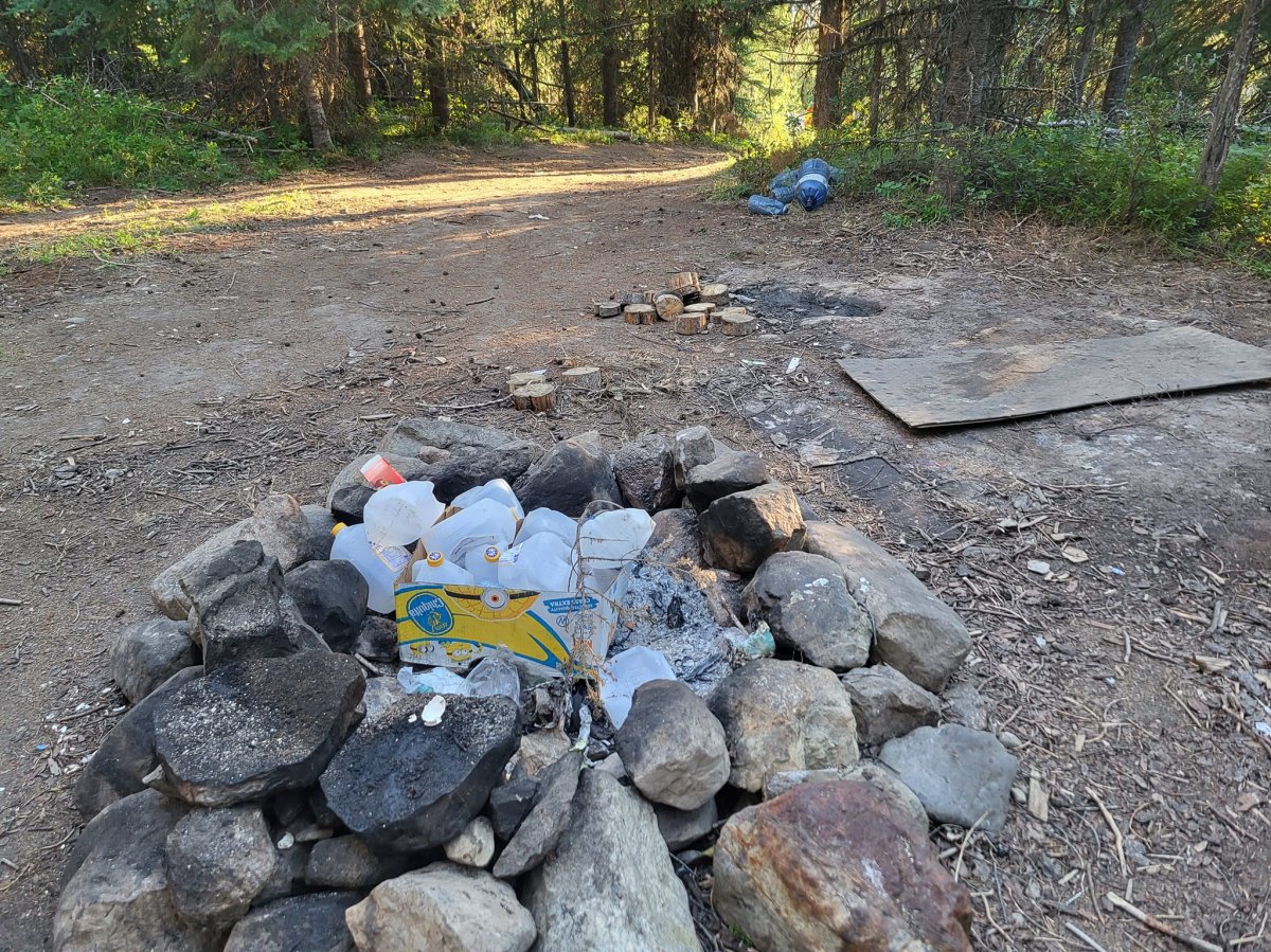 Garbage is piled up at an abandoned campsite in the Okanagan.