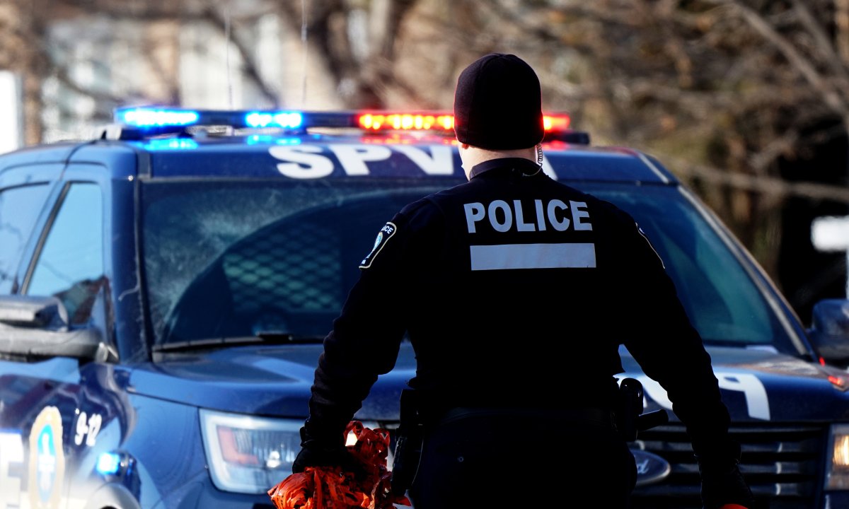 Montreal police officer at a crime scene in Montreal, Sunday, Feb. 14, 2021.