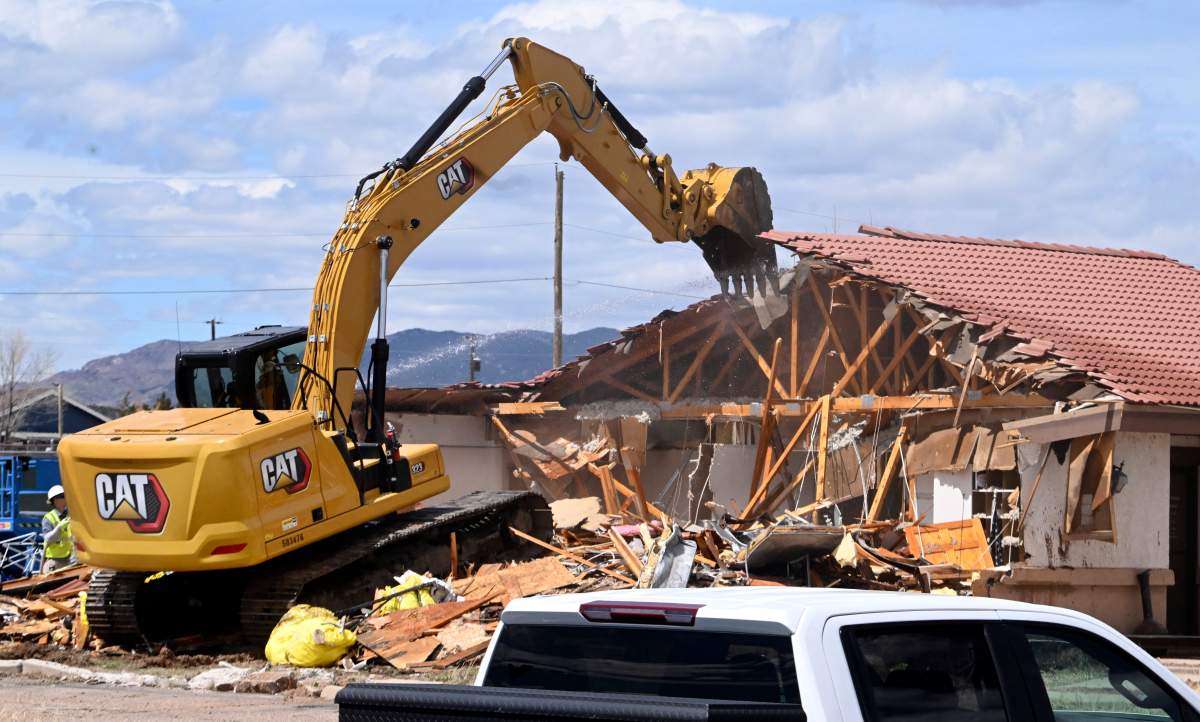 More than half of the Return to Nature Funeral Home was demolished by early afternoon in Colorado Springs, Colo., Tuesday, April 16, 2024.