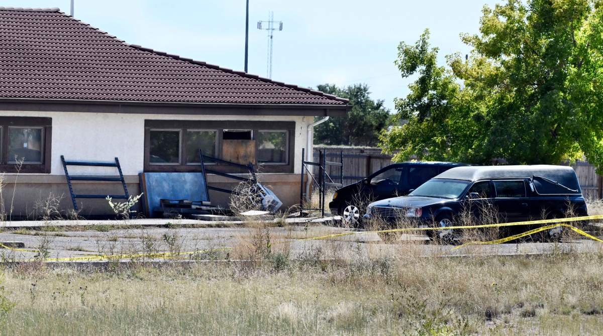 FILE - A hearse and debris can be seen at the rear of the Return to Nature Funeral Home, Oct. 5, 2023, in Penrose, Colo.