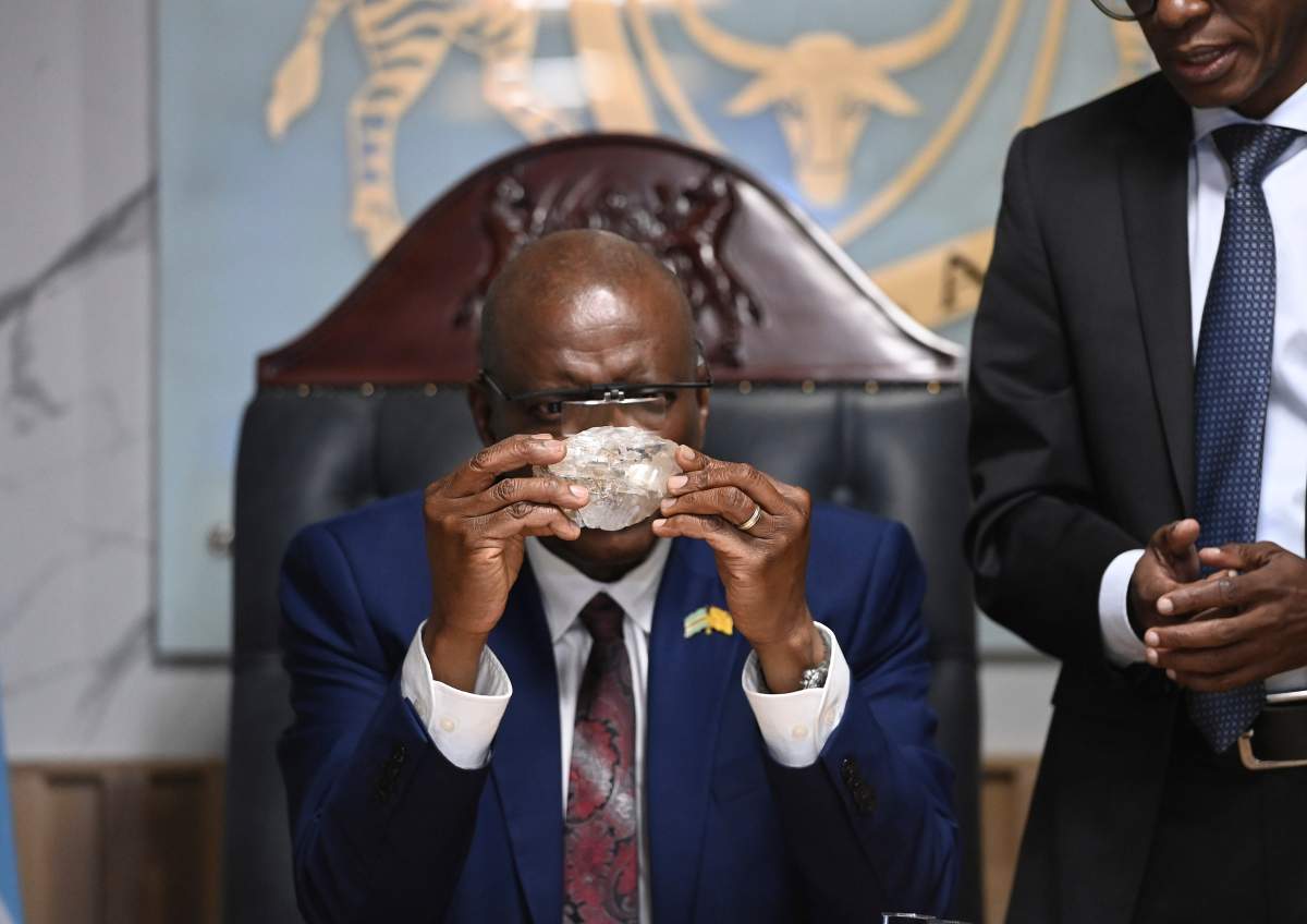 Botswana's President Mokgweetsi Masisi holds the 2,492-carat diamond that was unearthed at the Karowe mine, Thursday, Aug. 22, 2024, in Gaborone.