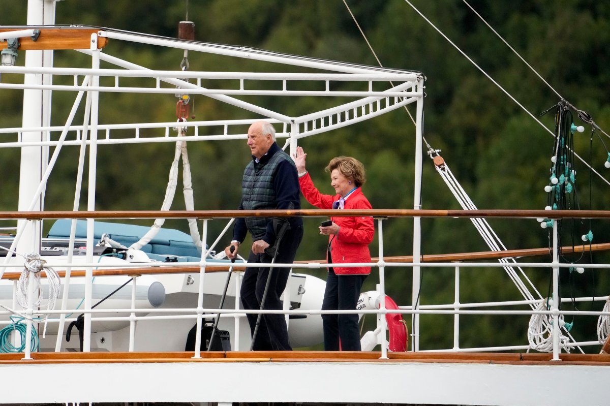 Norway's King Harald and Queen Sonja on board the Royal Yacht wave to the boats carrying wedding guests from Alesund to Geiranger, Norway, Friday Aug. 30, 2024, for the wedding celebration of Princess Martha Louise and Durek Verret on Saturday.