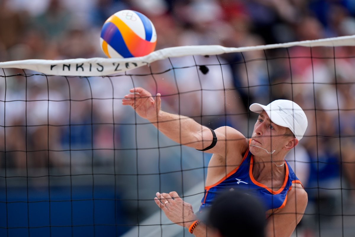 The Netherland's Steven van de Velde slams a shot over the net against Chile in a beach volleyball match at the 2024 Summer Olympics, Wednesday, July 31, 2024, in Paris, France.