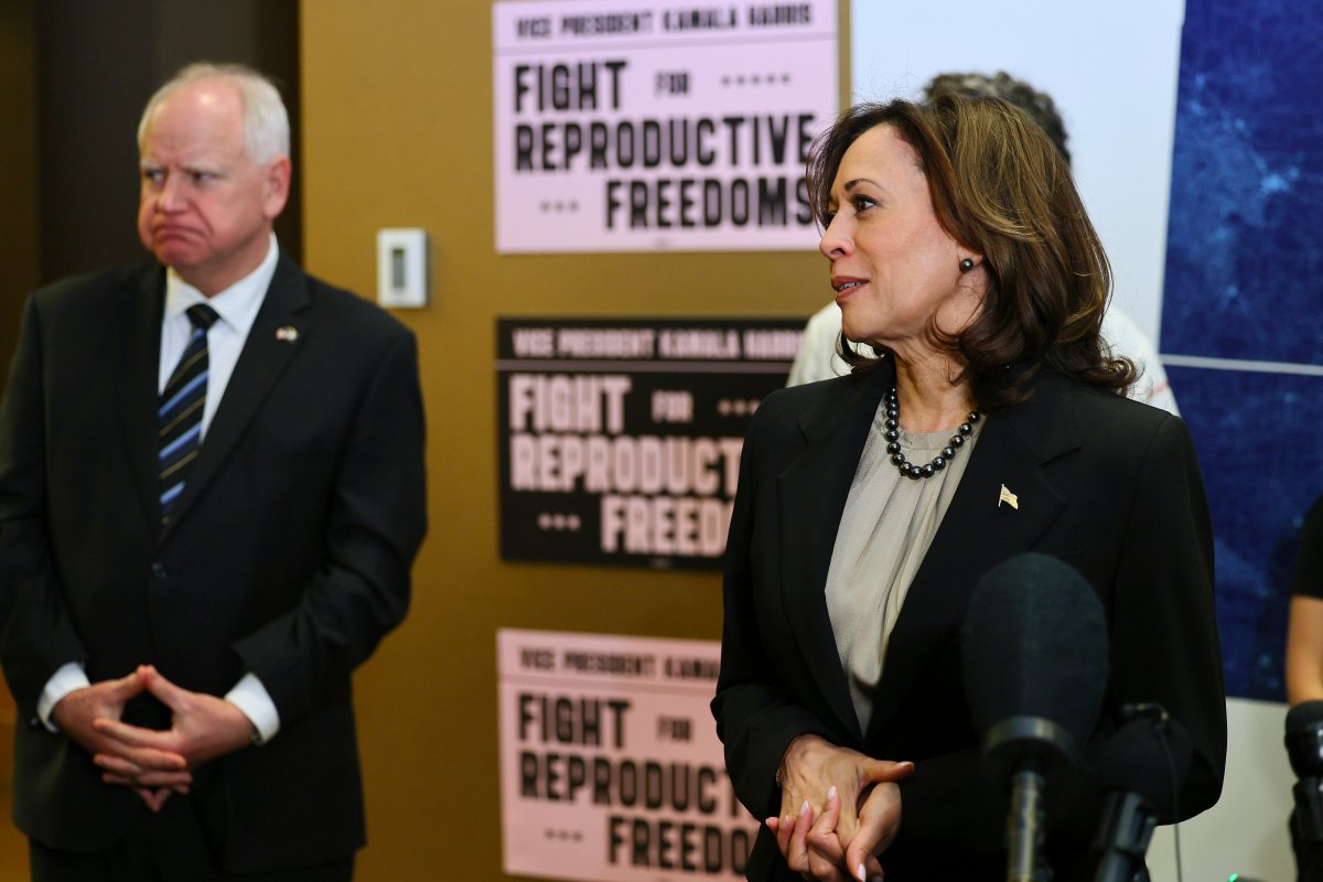 FILE – Minnesota Gove. Tim Walz listens to Vice-President Kamala Harris speak at Planned Parenthood, March 14, 2024, in St. Paul, Minn. (AP Photo/Adam Bettcher, File)