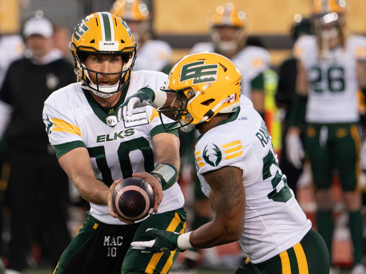 Edmonton Elks quarterback McLeod Bethel-Thompson (10) hands off to running back Justin Rankin (31) during first half CFL football game action against the Hamilton Tiger-Catsin Hamilton, Ont. on Saturday, August 17, 2024.