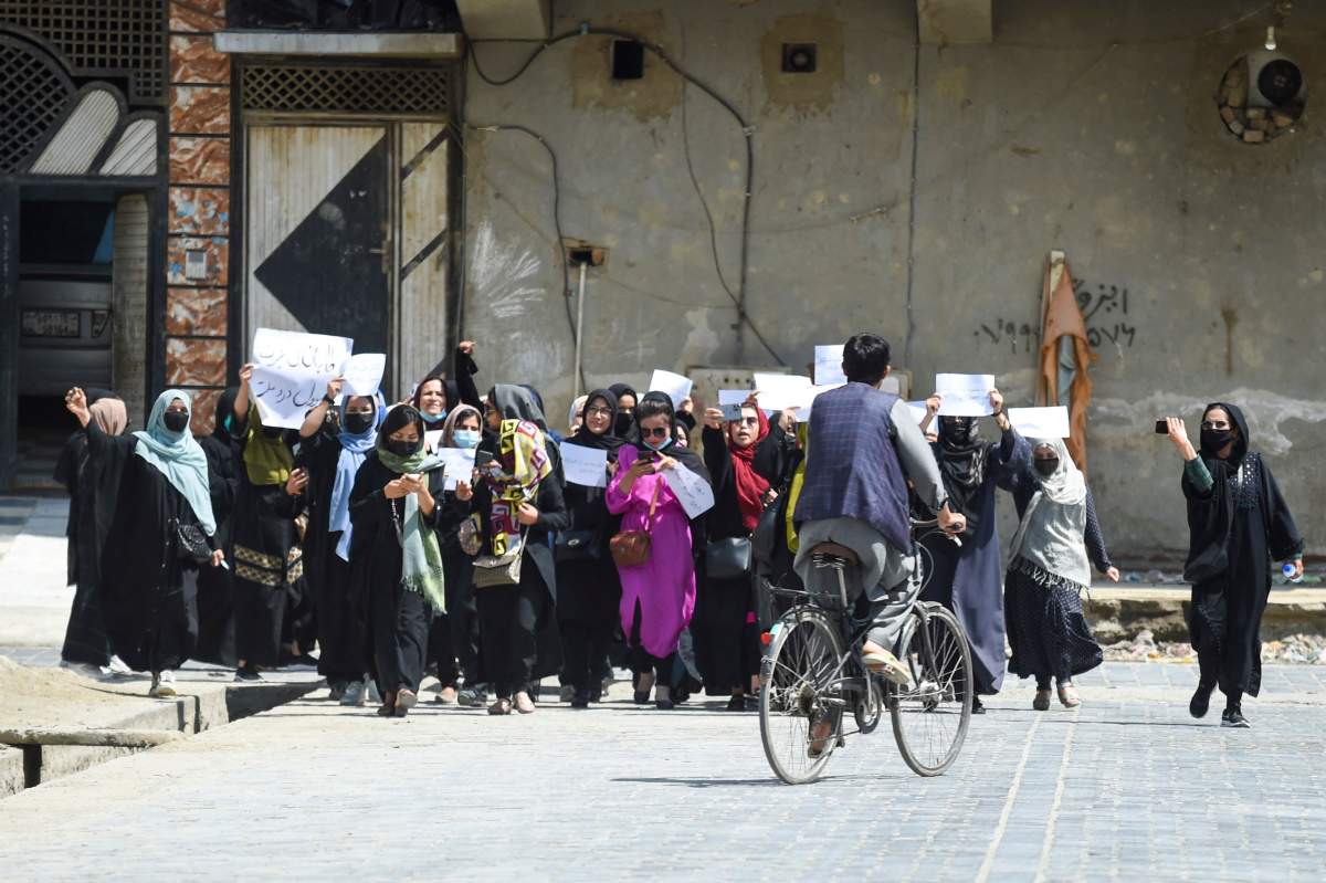 Afghan women hold placards as they march to protest for their rights, in Kabul on April 29, 2023, defying a dissent crackdown.