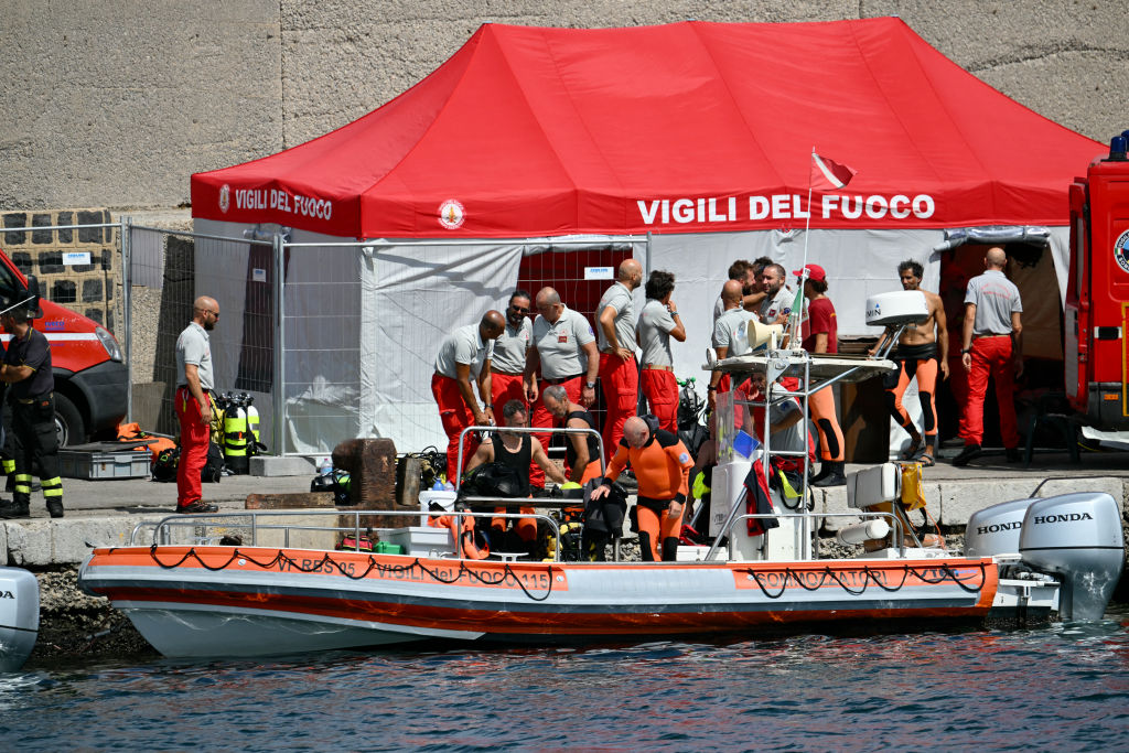 Divers of the Vigili del Fuoco, the Italian Corps. of Firefighters, return to Porticello on a small boat, on August 20, 2024.