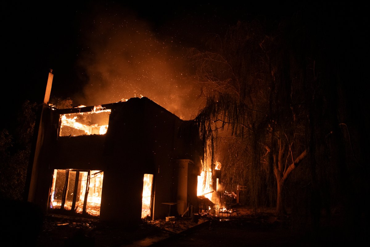 A house burns in Varnava village during a wildfire, north of Athens, Greece, Sunday, Aug. 11, 2024. Many regions of the country are on high alert due to high temperatures and winds. (AP Photo/Michael Varaklas)