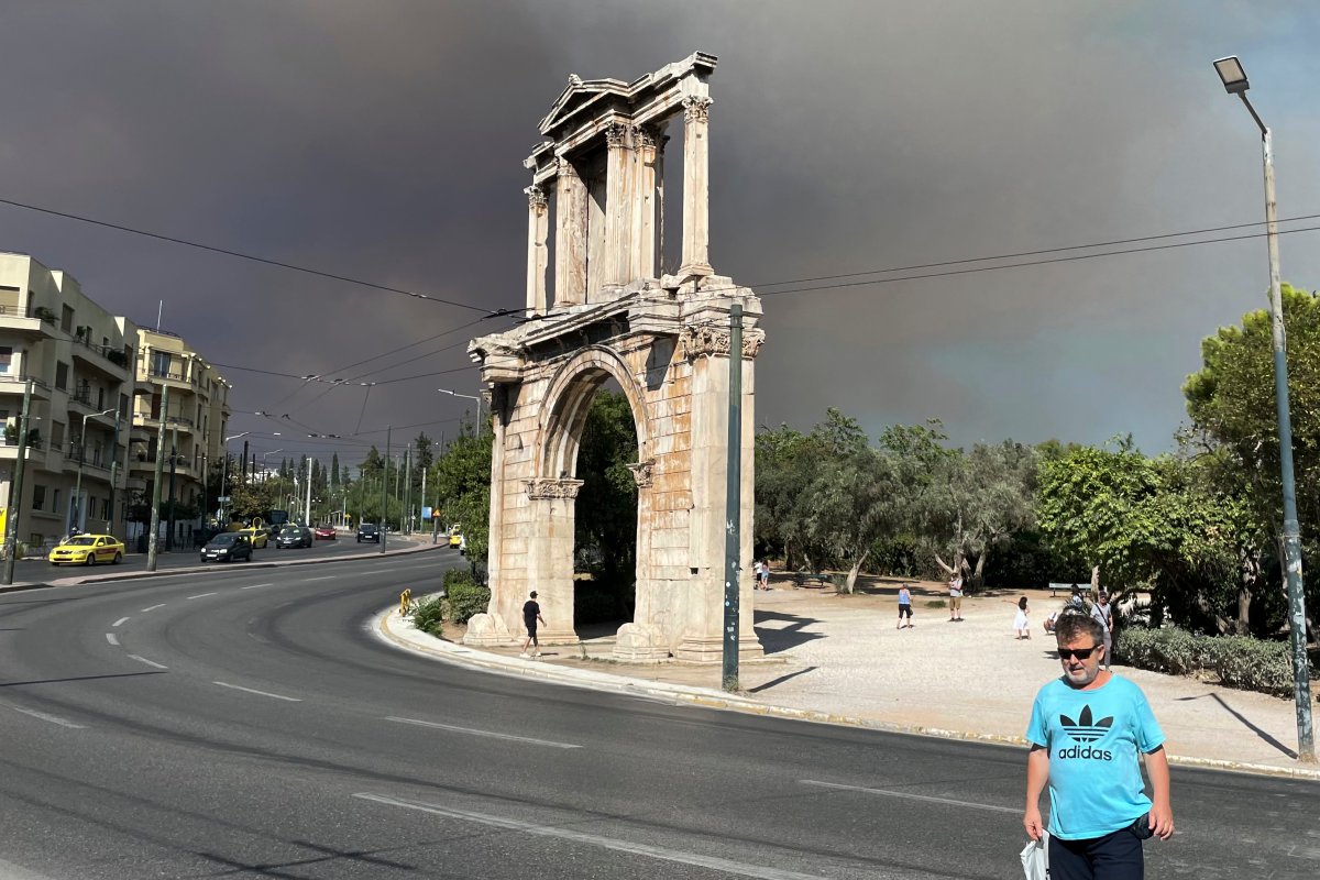 Smoke from wildfires is seen above the Hadrian's Arch in central Athens