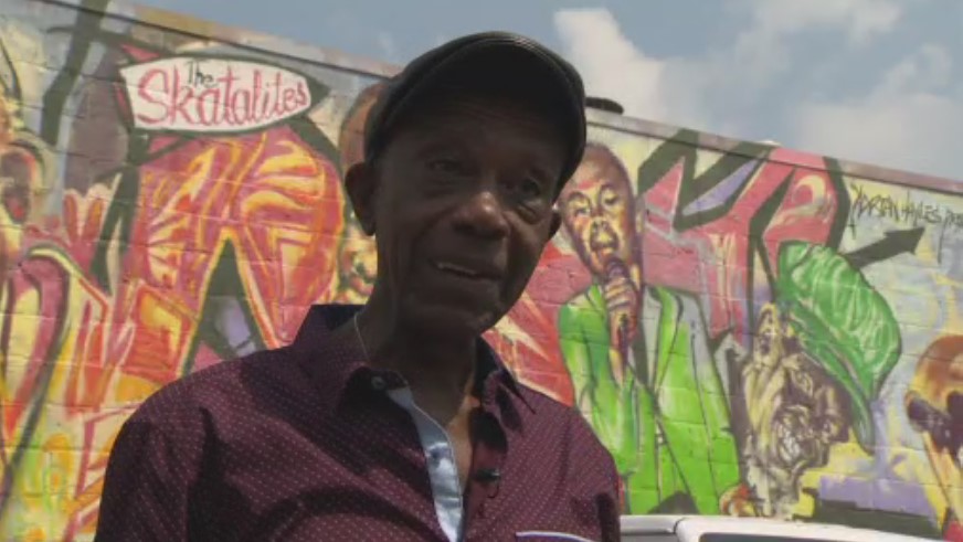 Jay Douglas in front of the Reggae Lane mural.