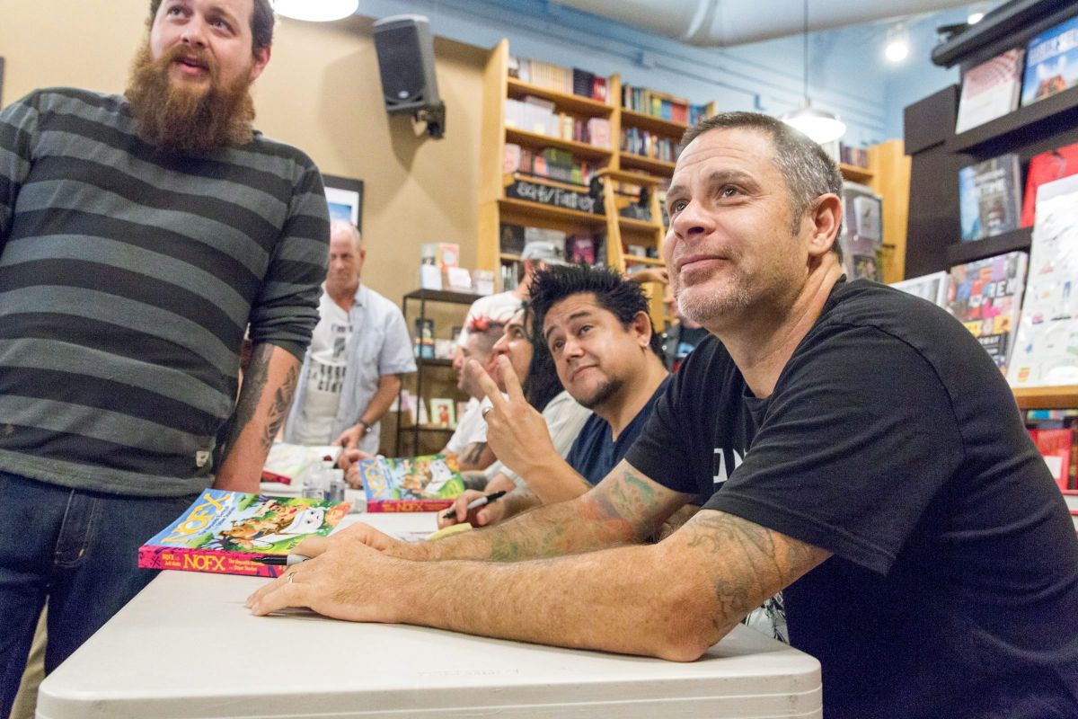 NOFX drummer Erik “Smelly” Sandin, right, and guitarist Aaron “El Hefe” Abeyta, centre, pose for a photo with a fan at a book signing at Parnassus Books in Nashville, Tenn., on Tuesday, April 26, 2016. The punk band is exchanging grimy music venues for highbrow bookstores while promoting their joint autobiography “NOFX: The Hepatitis Bathtub and Other Stories.”