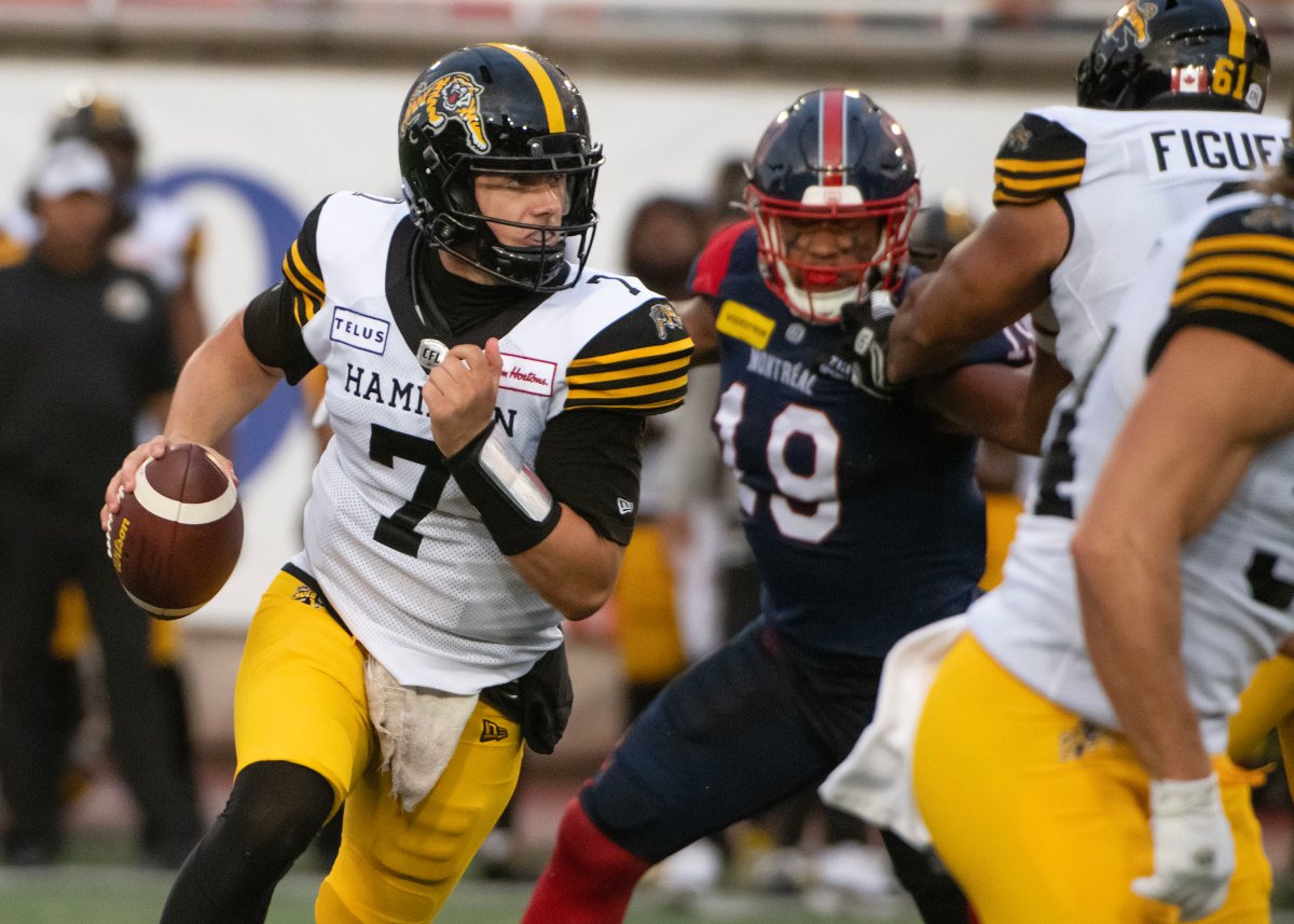 Hamilton Tiger-Cats quarterback Taylor Powell scrambles with the ball against the Montreal Alouettes during first half CFL action in Montreal on Saturday, Aug. 10, 2024.