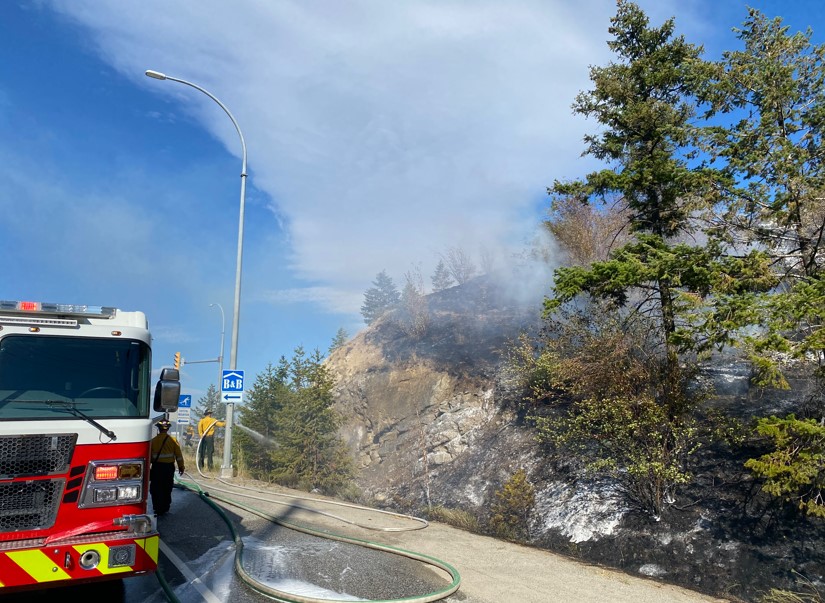 Shortly before 5pm Sunday evening, multiple 9-1-1 calls were received reporting a fire burning in the grass and trees at the Glenrosa/97 interchange at the south end of the City of West Kelowna. A plume of white smoke was highly visible across the city.