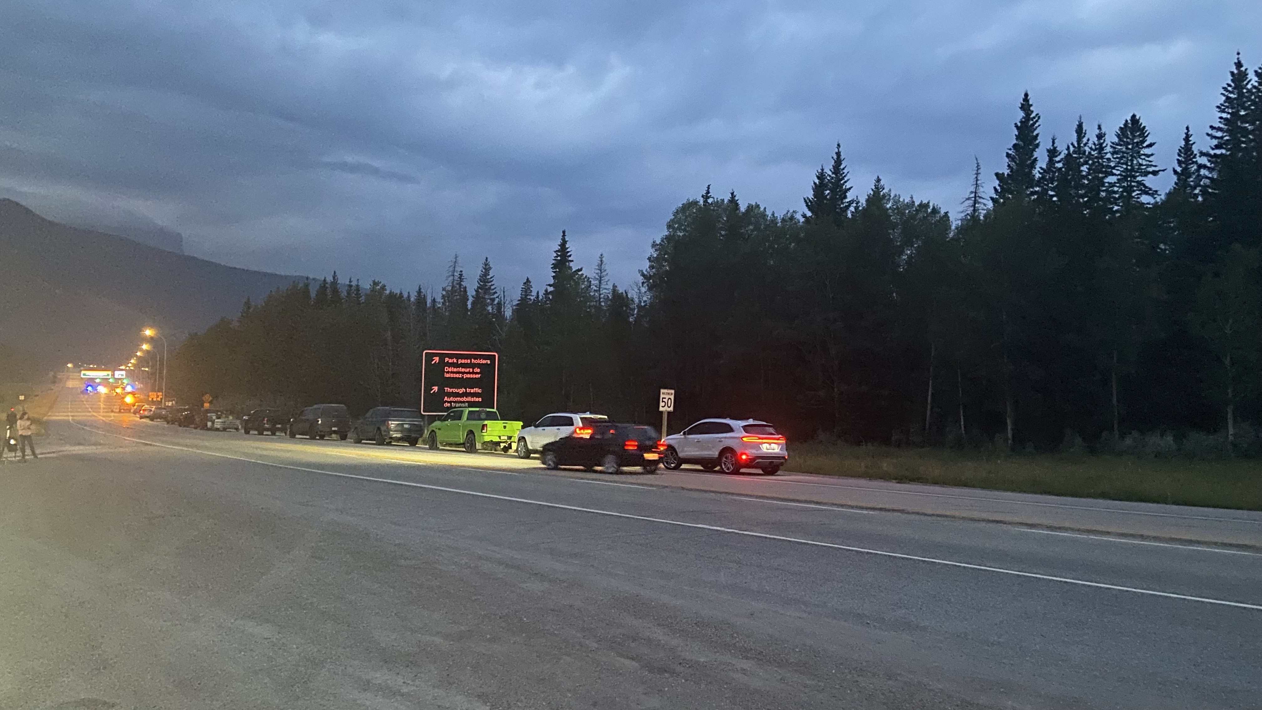 Jasper residents line up along Highway 16 as the town reopens Friday, Aug. 16, 2024.