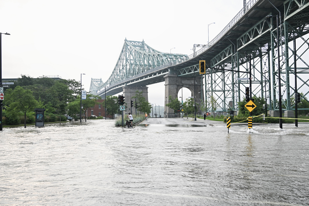 A flooded street is shown due to a broken watermain in Montreal, Friday, August 16, 2024, causing flooding in several streets of the area.