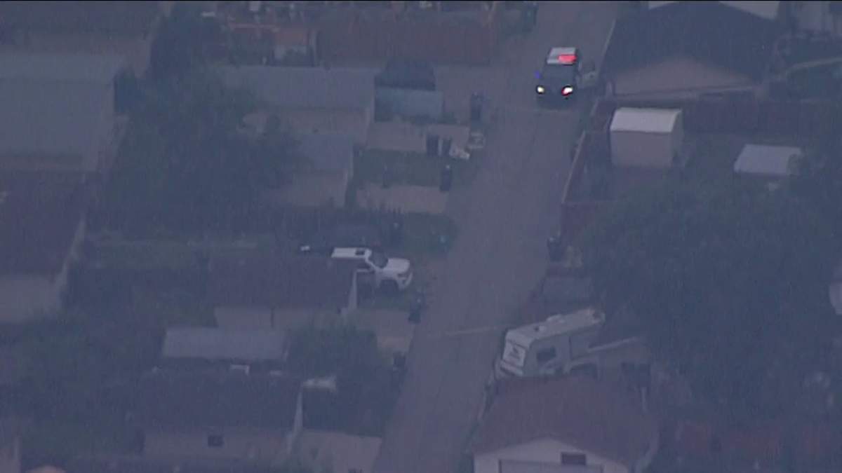 Several emergency vehicles surround a home in the area of 15th Avenue and 54th Street in Edmonton Wednesday, Aug. 14, 2024.