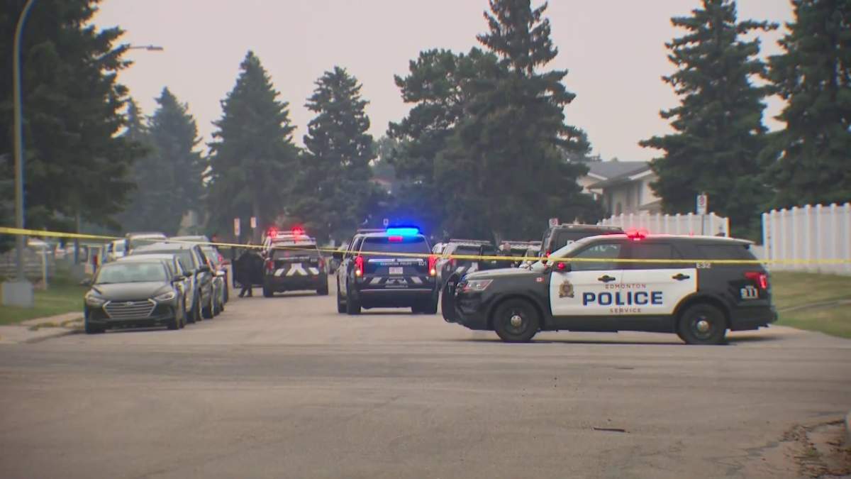 Several emergency vehicles surround a home in the area of 15th Avenue and 54th Street in Edmonton Wednesday, Aug. 14, 2024.