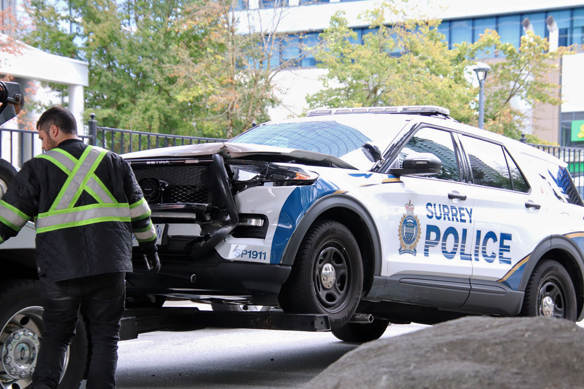 A Surrey police vehicle is towed away after Mounties say someone rammed it on Wednesday.