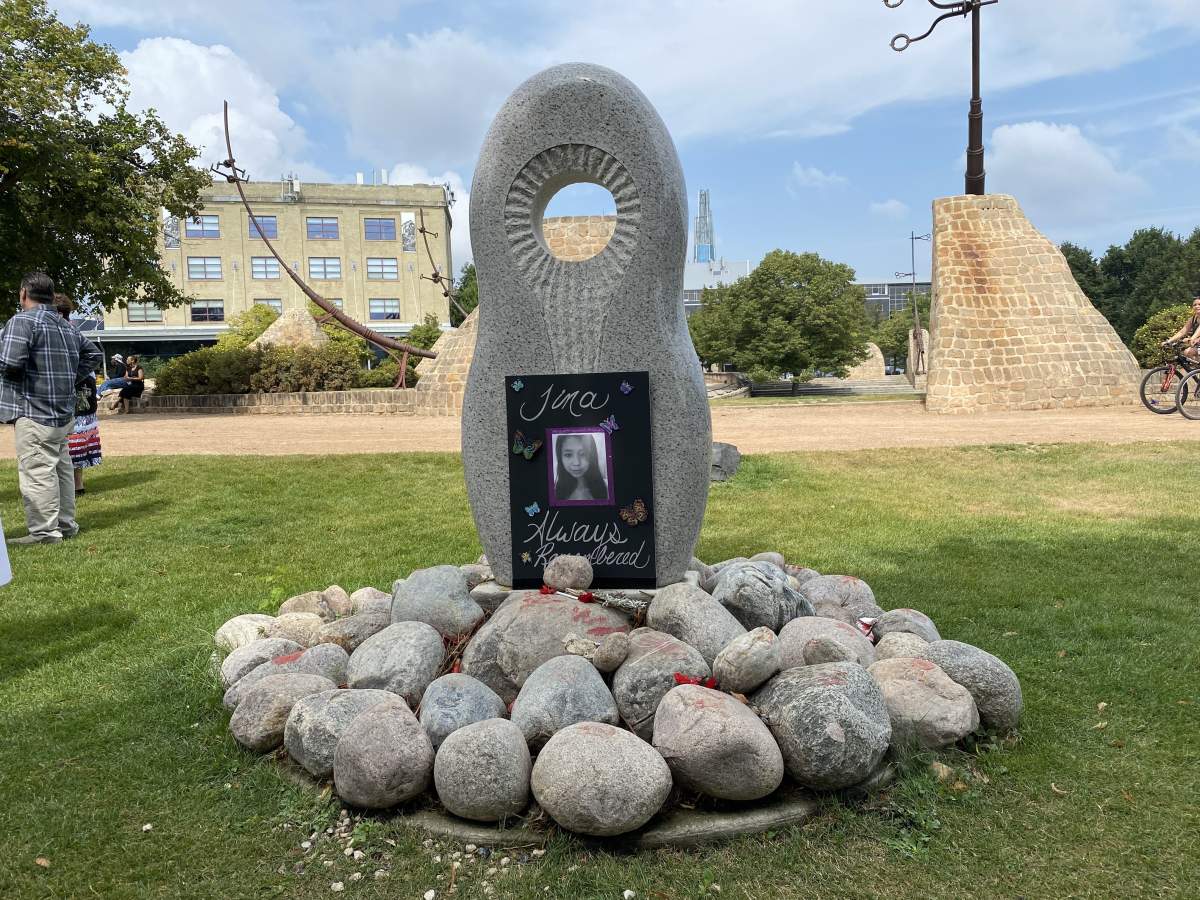 A memorial honouring Missing and Murdered Indigenous Women and Girls is seen at The Forks in Winnipeg. A photo in memory of Tina Fontaine rests on it.