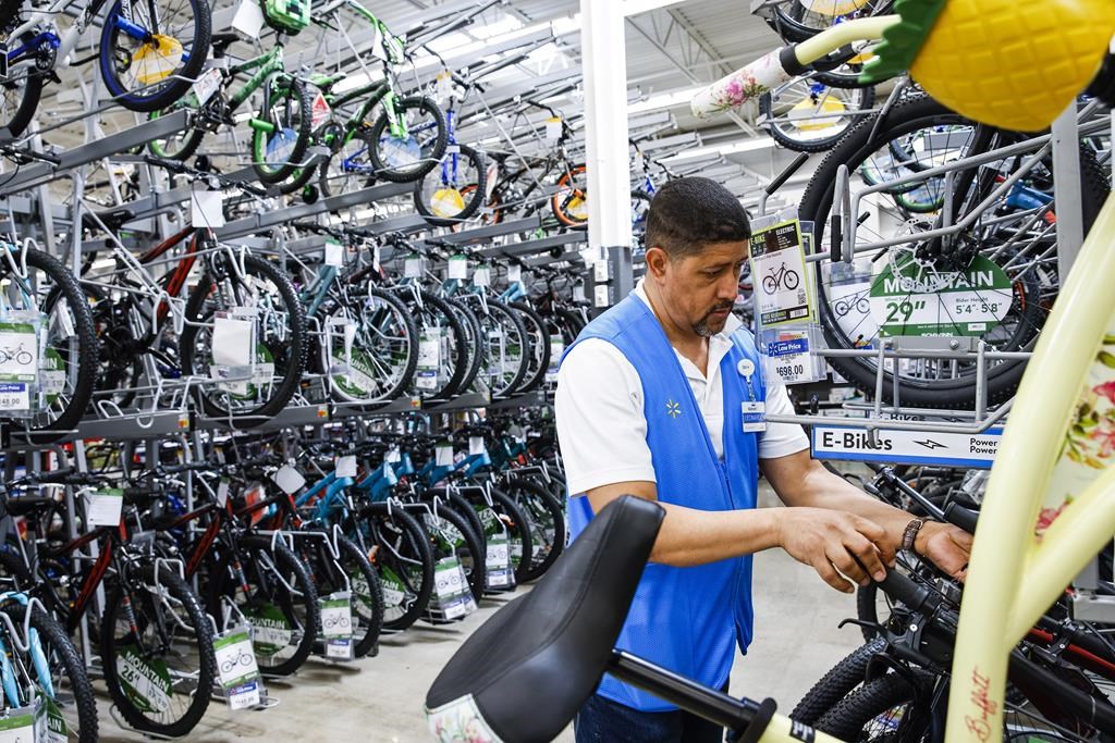 A worker organizes bicycles on a rack at a Walmart Superstore in Secaucus, N.J.,