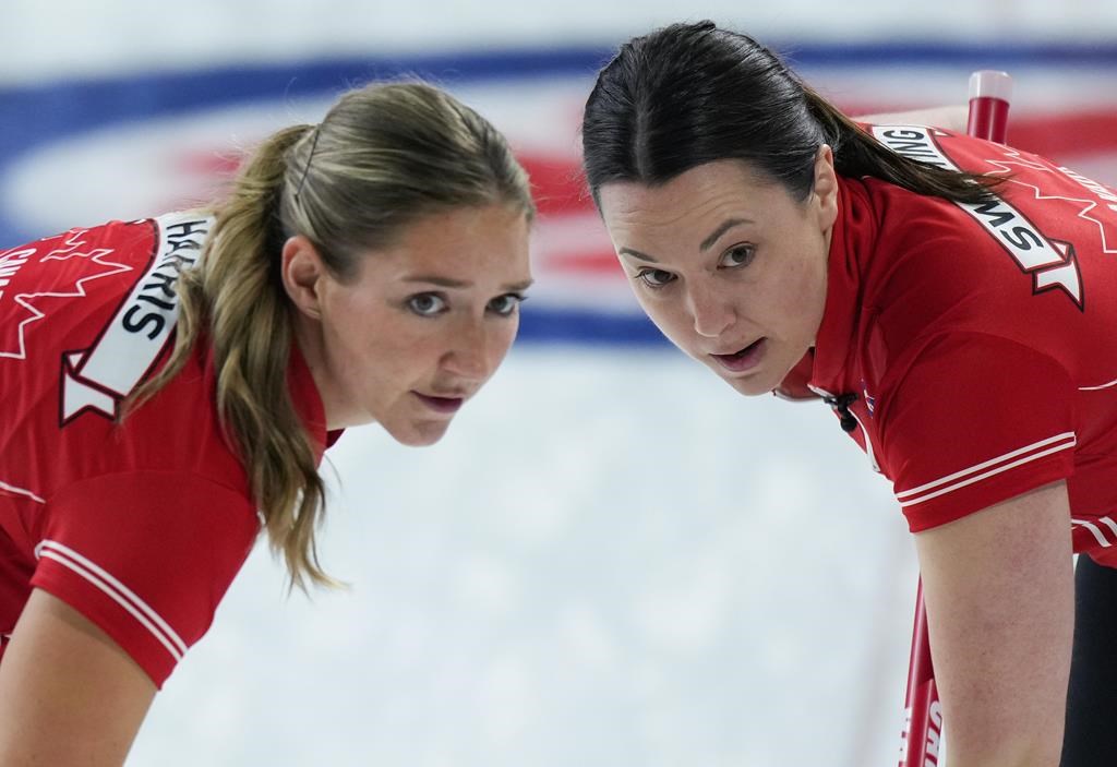 Team Canada lead Briane Harris, left, and third Val Sweeting sweep while playing Prince Edward Island at the Scotties Tournament of Hearts, in Kamloops, B.C., on Monday, Feb. 20, 2023.