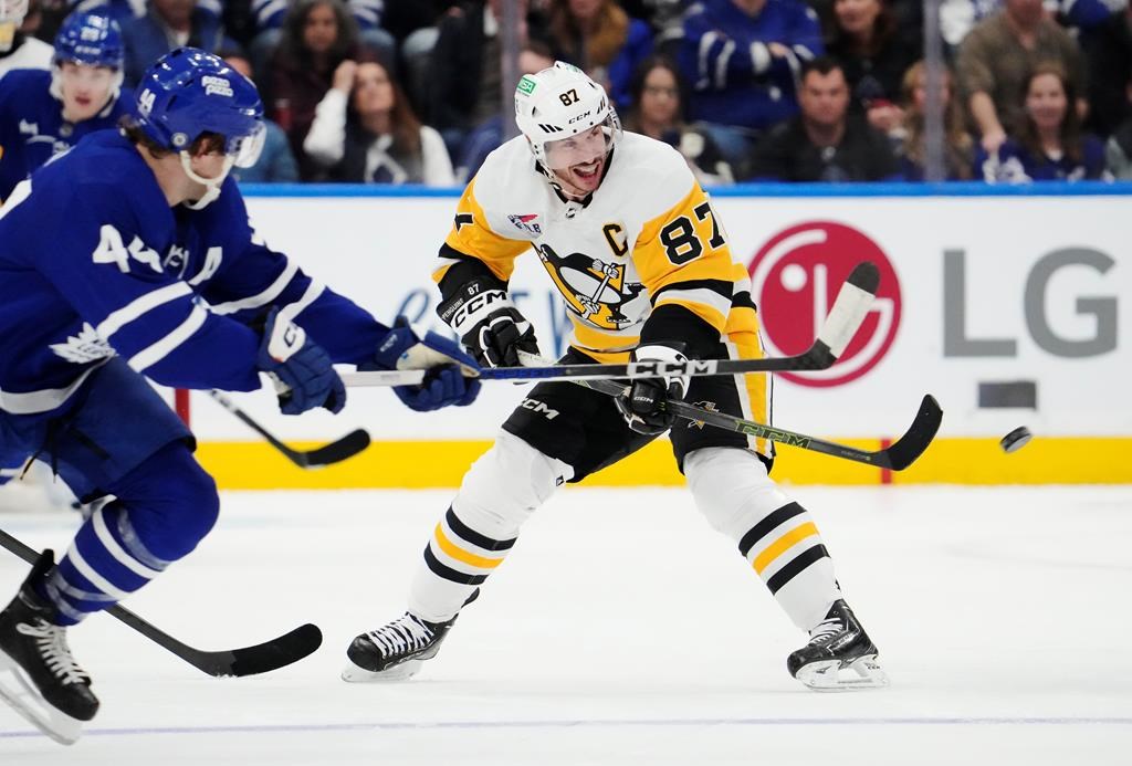 Pittsburgh Penguins' Sidney Crosby (87) passes as Toronto Maple Leafs' Morgan Rielly (44) defends during third period NHL hockey action in Toronto on Monday, April 8, 2024. Sidney Crosby is confident he will have a new contract signed before the start of the NHL regular season. THE CANADIAN PRESS/Frank Gunn.