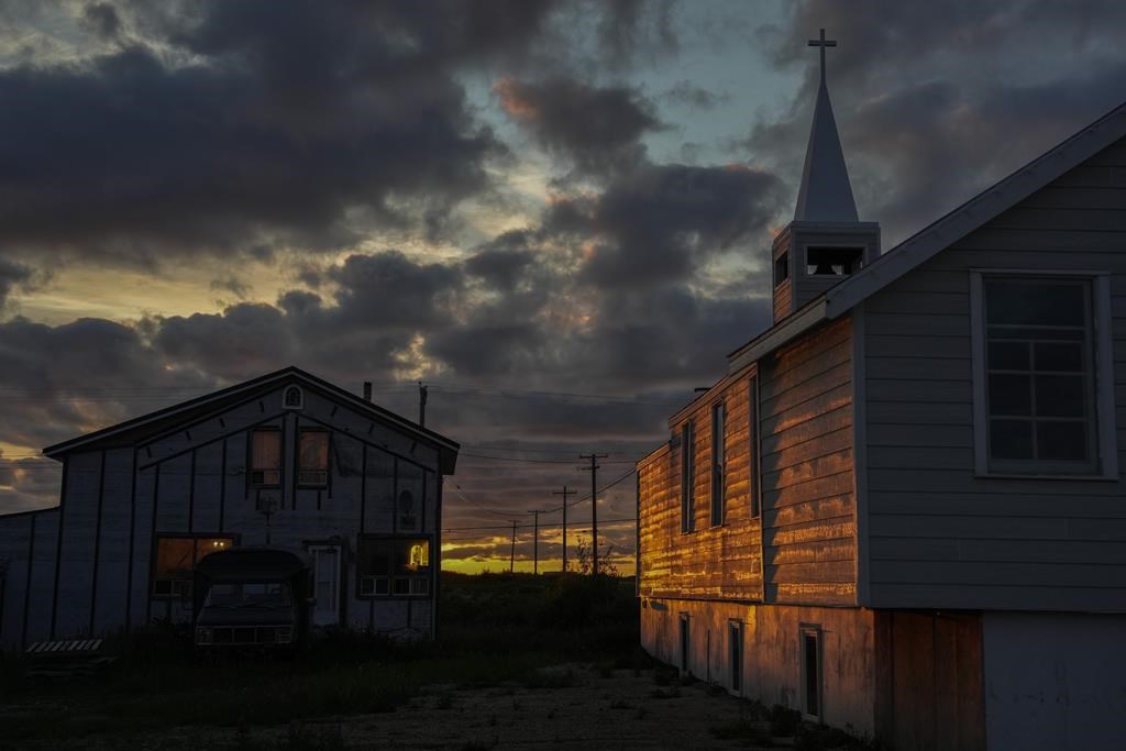 The setting sun illuminates the Anglican Church, Sunday, Aug. 4, 2024, in Churchill, Manitoba.