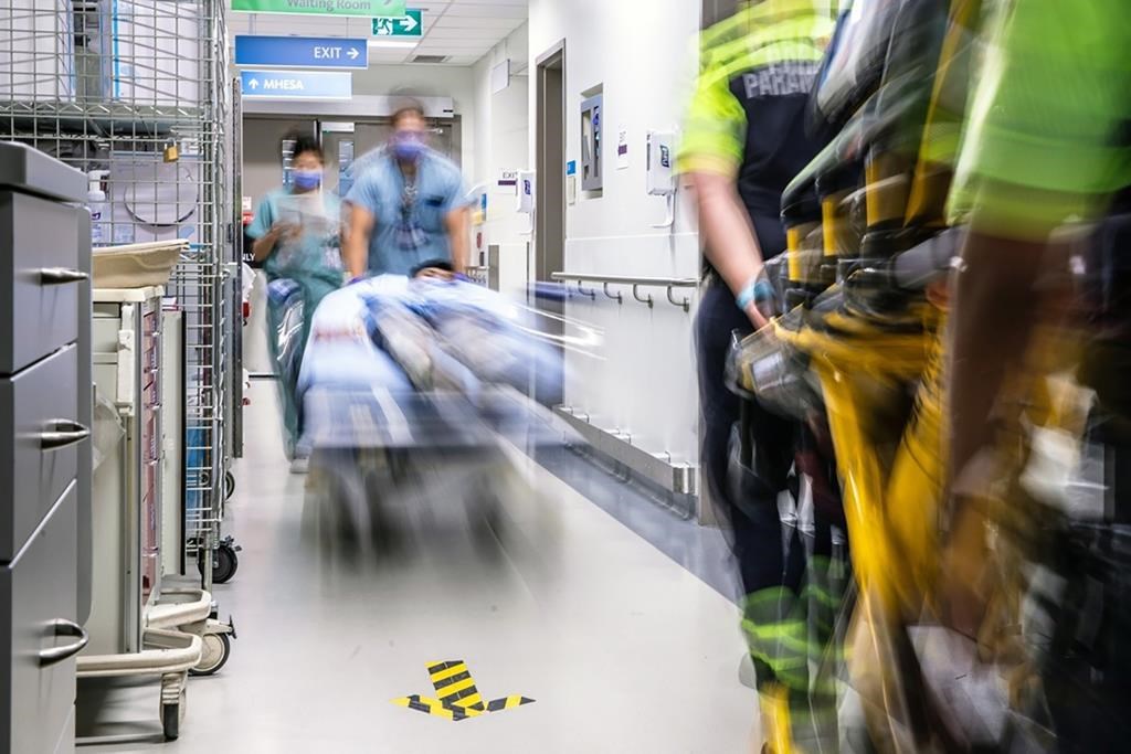 Hospital workers roll patients down a corridor at a hospital in Toronto in this undated photo. An AI early-warning system that predicts which patients are at risk of deteriorating while in hospital was associated with a decrease in unexpected deaths, a new study says. THE CANADIAN PRESS/HO Unity Health Toronto.