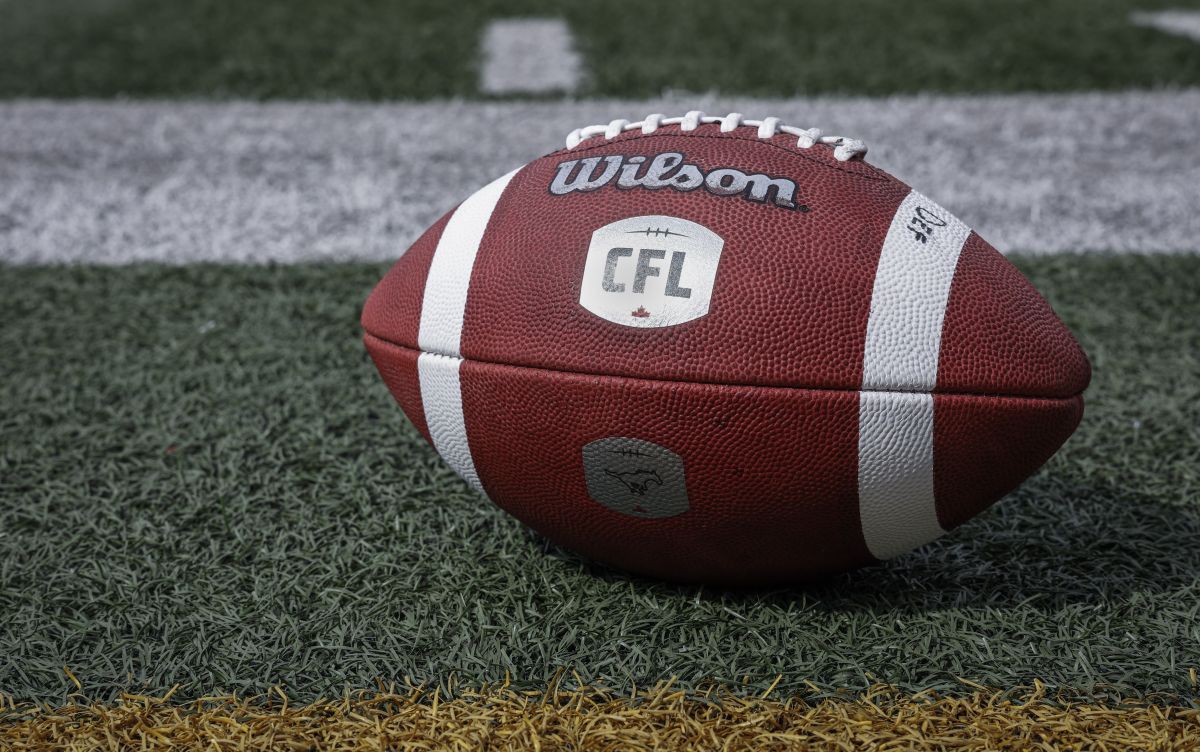 A football sits on the sidelines as the Calgary Stampeders runs drills during opening day of training camp in Calgary, Alta., Sunday, May 12, 2024.