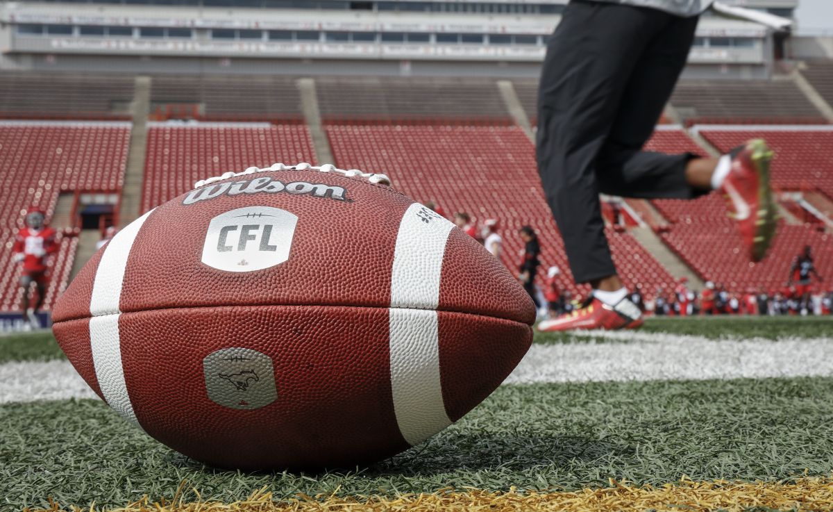 A football sits on the sidelines as the Calgary Stampeders runs drills during opening day of training camp in Calgary, Alta., Sunday, May 12, 2024.