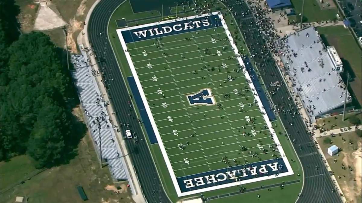 Students are evacuated to the football stadium after the school campus was placed on lockdown at Apalachee High School in Winder, Ga., on Wednesday, Sept. 4, 2024. (WSB via AP)