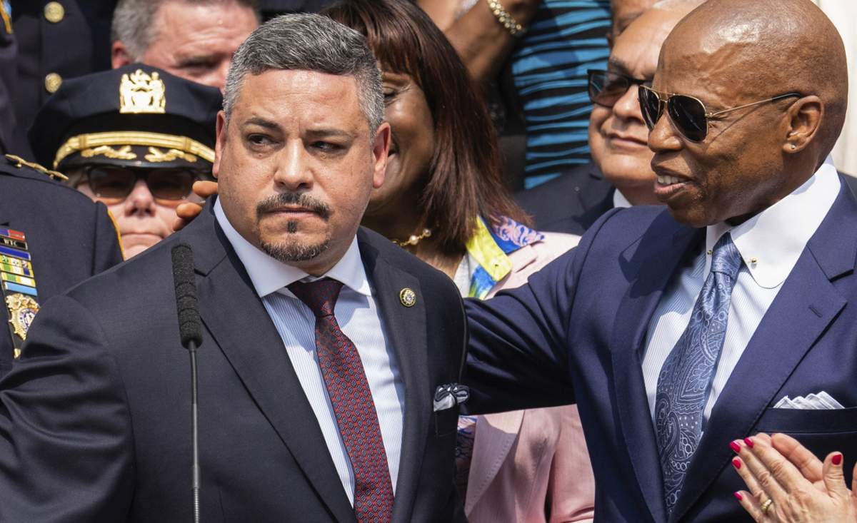 FILE - Edward A. Caban, left, speaks after being sworn in as NYPD police commissioner outside New York City Police Department 40th Precinct, July 17, 2023, in New York. Mayor Eric Adams on the right. (AP Photo/Jeenah Moon, File).