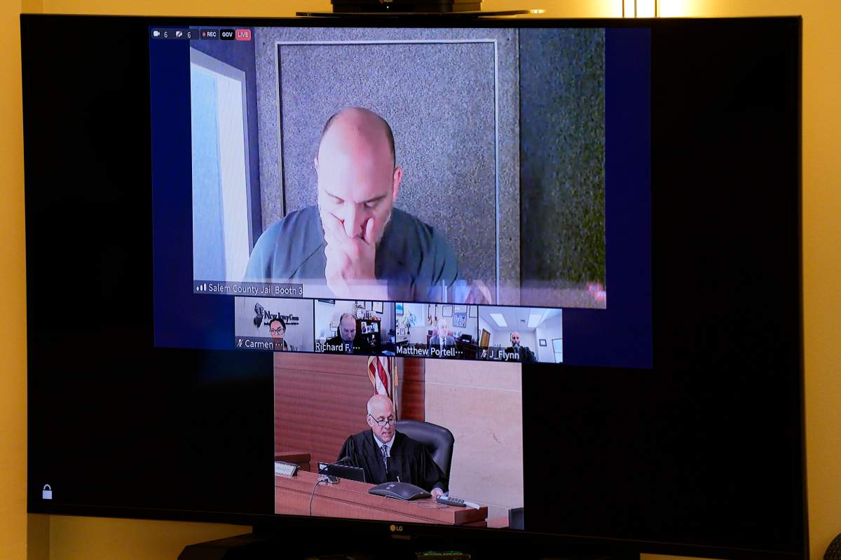 Sean M. Higgins, top, the alleged drunken driver charged with killing NHL hockey player Johnny Gaudreau and his brother Matthew as they bicycled on a rural road, appears before Judge Michael Silvanio, for his hearing via video from jail, Friday, Sept. 13, 2024, in Woodbury, N.J.