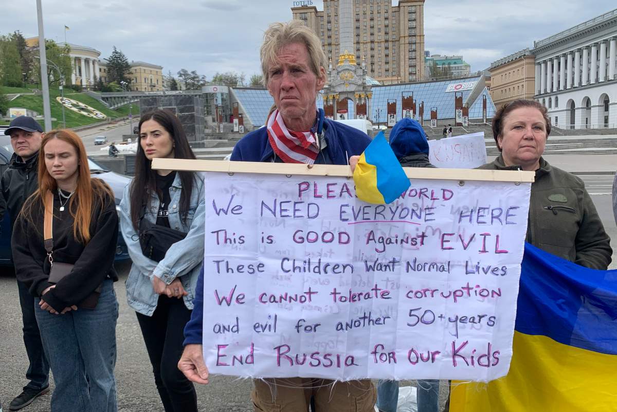 Ryan Wesley Routh holds up a banner during a rally in central Kyiv, Ukraine on Saturday April 30, 2022.