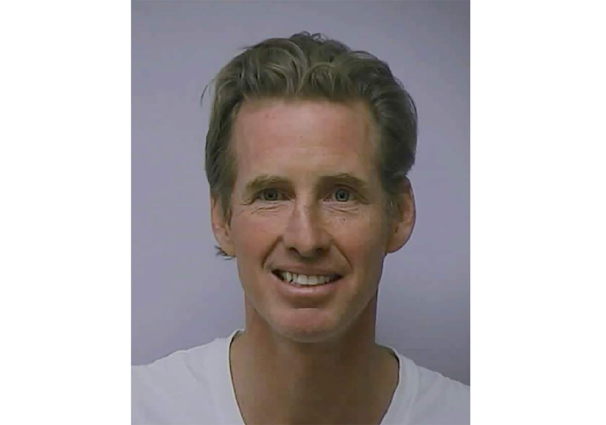 This image provided by the Guilford County Sheriff’s Office shows a Feb. 10, 2010 booking photo of Ryan Wesley Routh smiling.