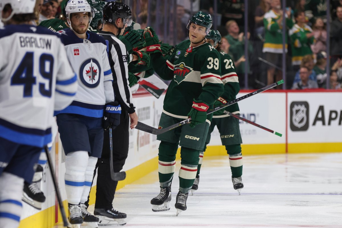 Minnesota Wild center Ben Jones (39) is congratulated by teammates after scoring against the Winnipeg Jets during the second period of a preseason NHL hockey game Friday, Sept. 27, 2024, in St. Paul, Minn. (AP Photo/Bailey Hillesheim).