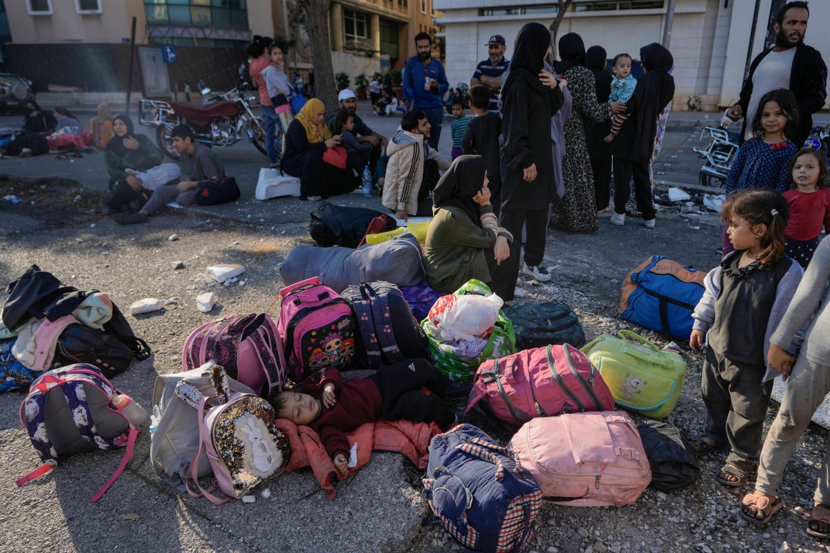 Families gather in Martyrs' square after fleeing the Israeli airstrikes in Beirut's southern suburbs, Saturday, Sept. 28, 2024.