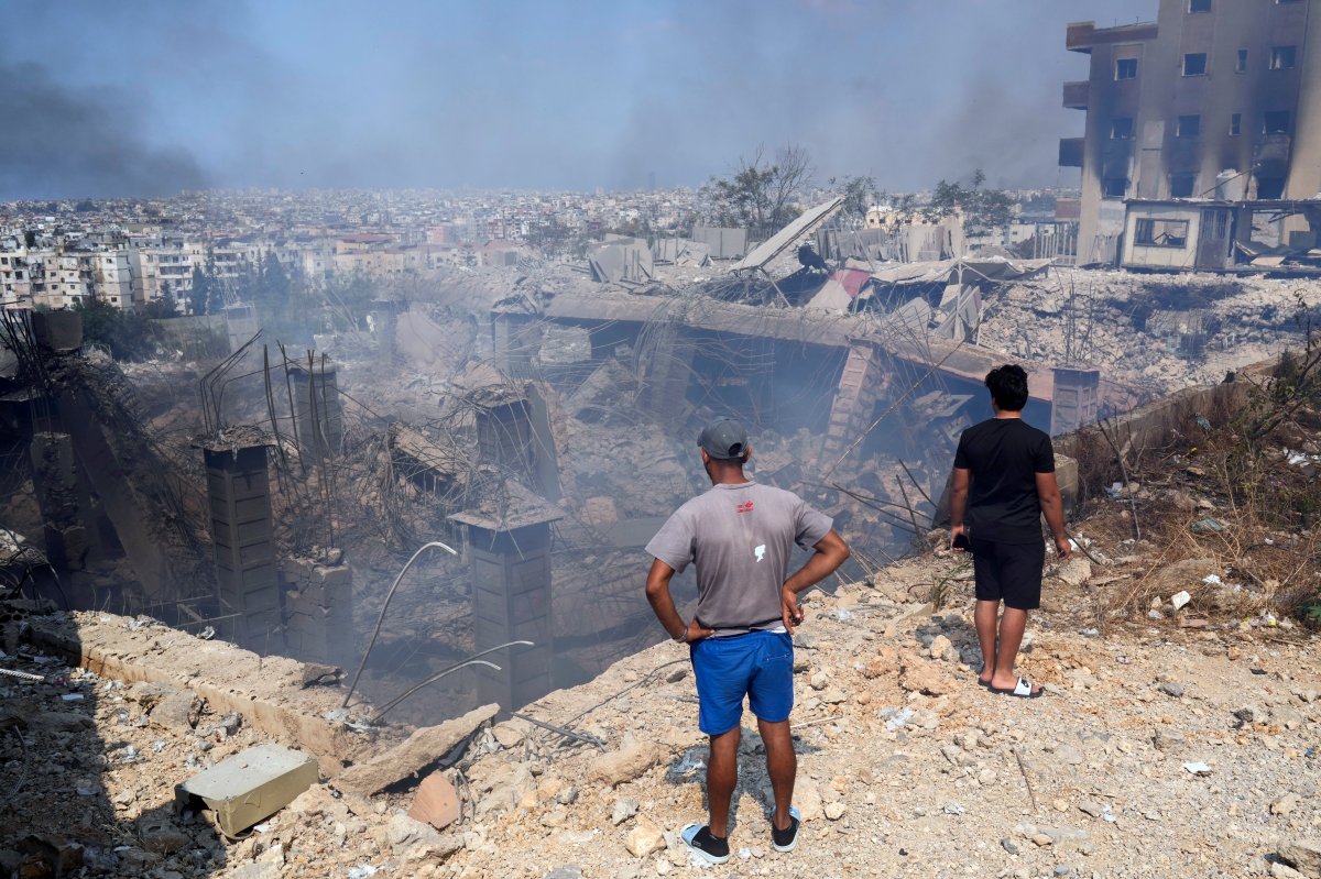 People check a damaged building at the site of an Israeli airstrike in Choueifat, south east of Beirut, Saturday, Sept. 28, 2024.